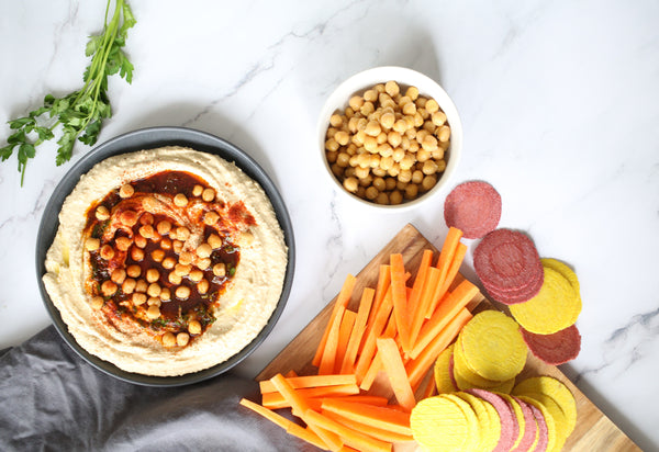 hummus dip recipe with chickpeas, carrots crackers and charcoal grey linen napkin
